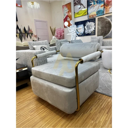 LIGHT-GREY LINT ROTATING CHAIR WITH GOLD STEEL FRAME.